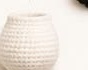 Firmly stuffed white crocheted panda body, rounded barrel shape with the top closed off