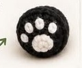 Black panda paw with a white paw pad pattern embroidered on: one large pad below three small toe pads, plus an arrow showing the stitching direction
