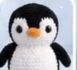 Small finished penguin head and body piece, worked as one continuous black and white shape with safety eyes already attached