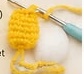 Small yellow crocheted Pikachu leg, worked with a hook still through the last stitch
