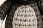 Finished gray crocheted Tom body, the rounded torso with a lighter belly patch visible at center
