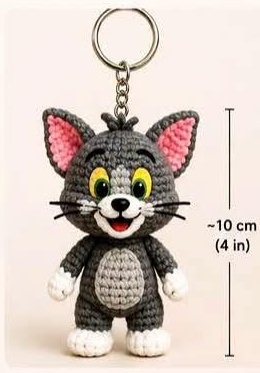 Finished crocheted Tom keychain amigurumi hanging from its ring, about 10cm (4in) tall
